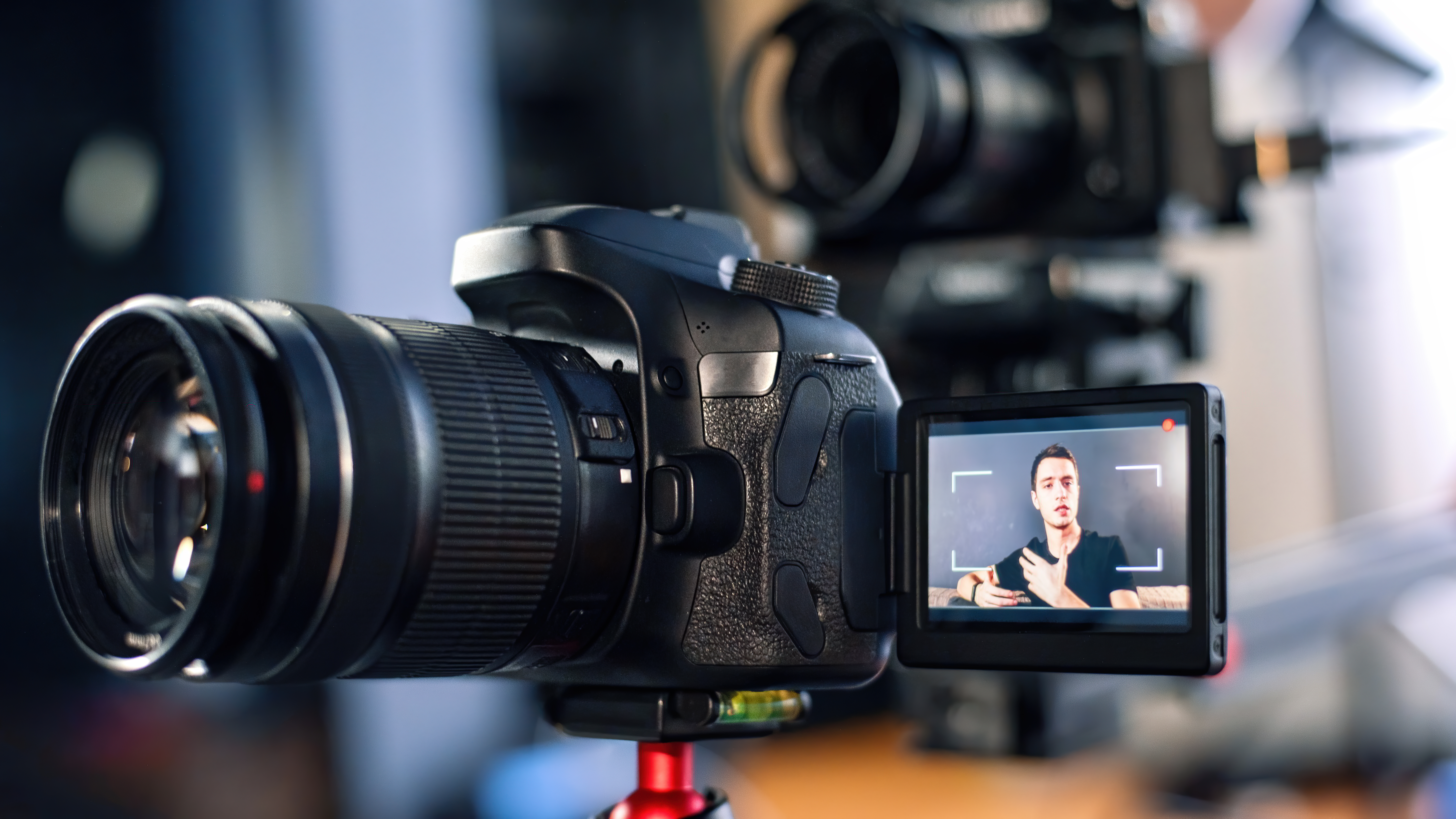Man Talking At The Camera Recording Himself In Vlog Working From Home Young Content Creator Multiple Cameras