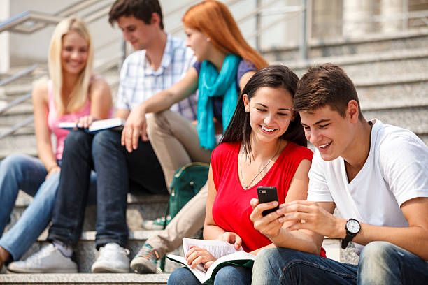 Group Of University Students Relaxing Outdoors
