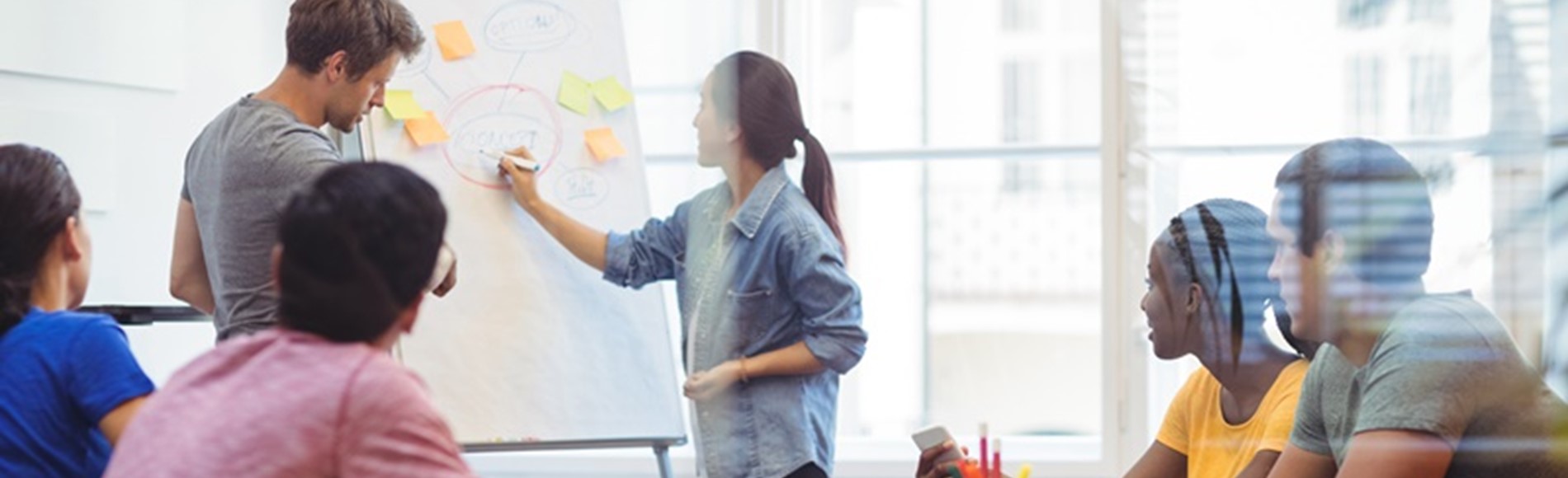 Business Executives Discussing With Their Colleagues On Whiteboa (1)