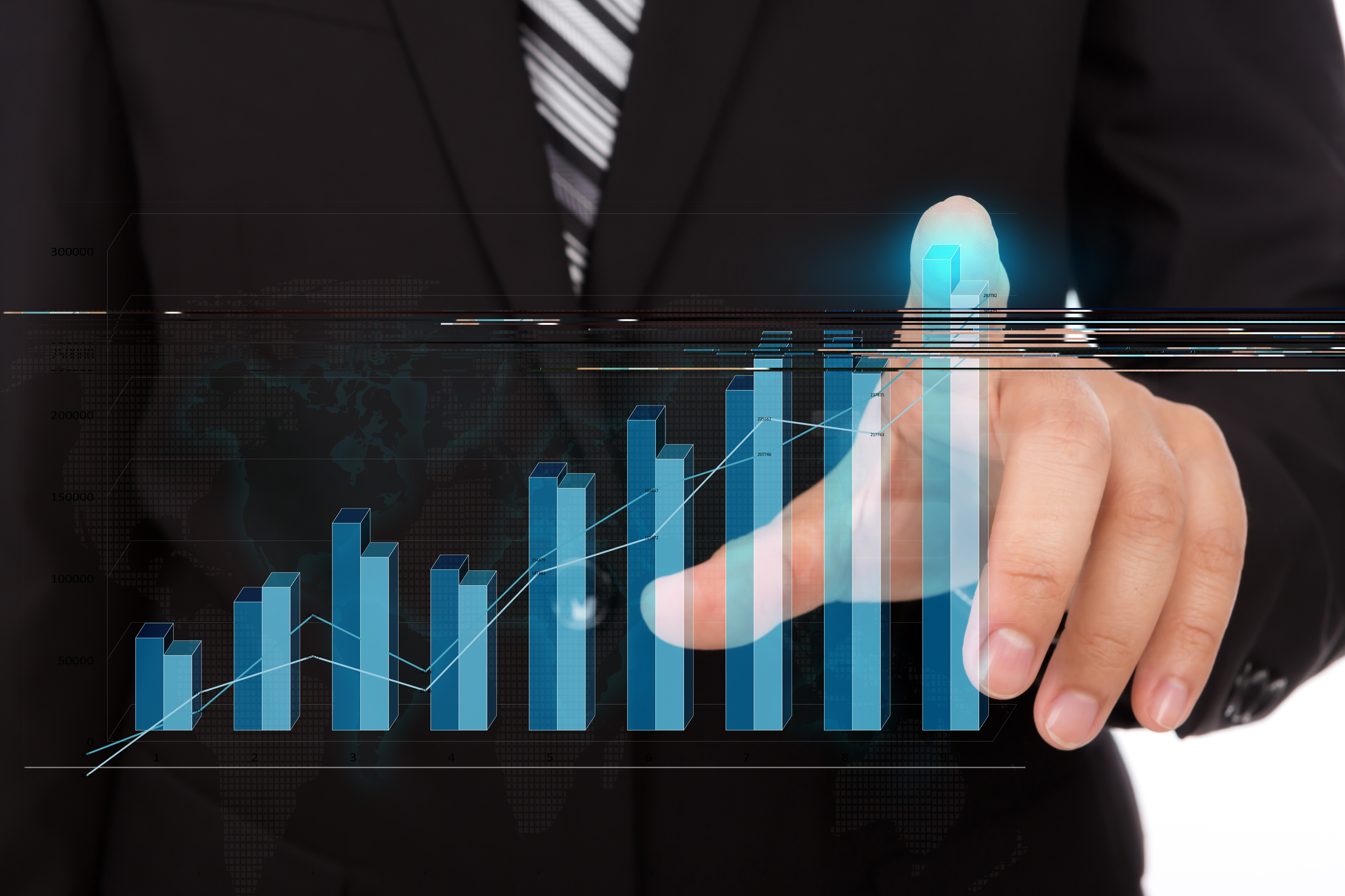 Businessman Touching The Tip Of Bar Chart
